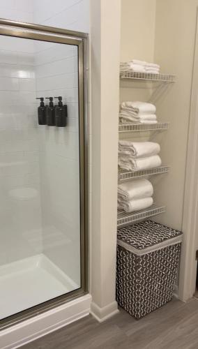 a bathroom with a shower and a mirror and towels at Atlanta Beltline Luxury Double Suite in Atlanta