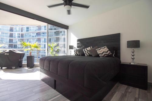 a bedroom with a large bed and a large window at Suites at Aria Luxury Double Suite on the Pacific Coast in Nuevo Vallarta 