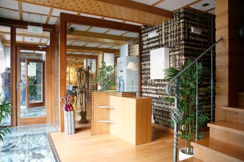 a lobby with plants and a staircase in a building at Hotel Casa de Caldelas in Castro Caldelas