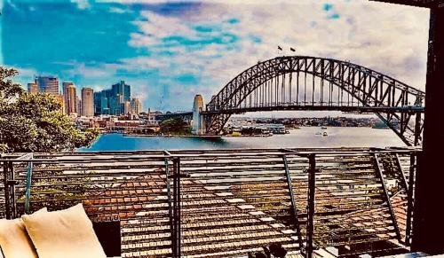 a bridge over a river with a city in the background at Breathtaking Sydney Harbour view condo in Sydney