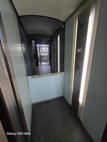 a small hallway with a window and a door at Luxury Vista Mar Apartment in Martil