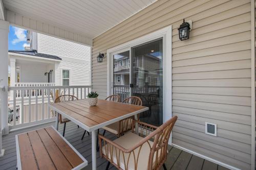 a patio with a table and chairs on a porch at Capers Blade - Across From Beach - Garage in Myrtle Beach