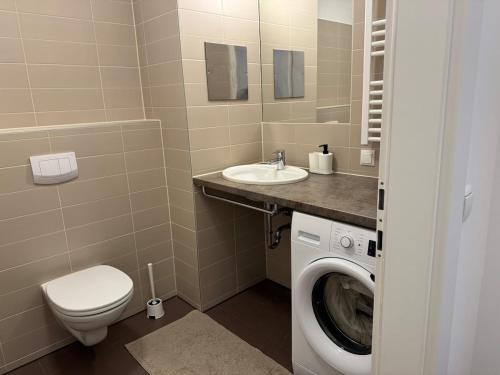 a bathroom with a washing machine and a sink at 2BR, balcony, central, danube, U6 & S-Bahn - Axara Housing BRN 22 in Vienna