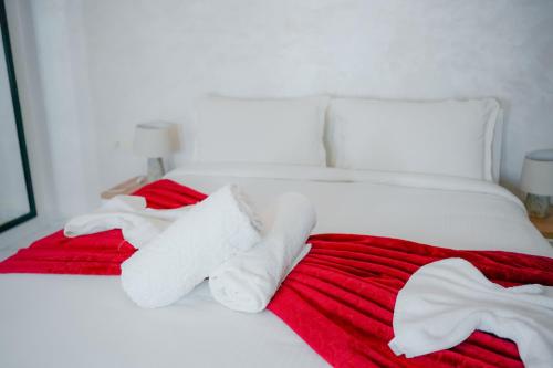 a white bed with red and white towels on it at RIAD REDWAN in Marrakech