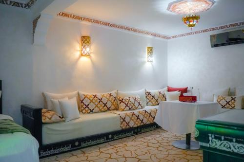 a living room with a couch and a table at RIAD REDWAN in Marrakech