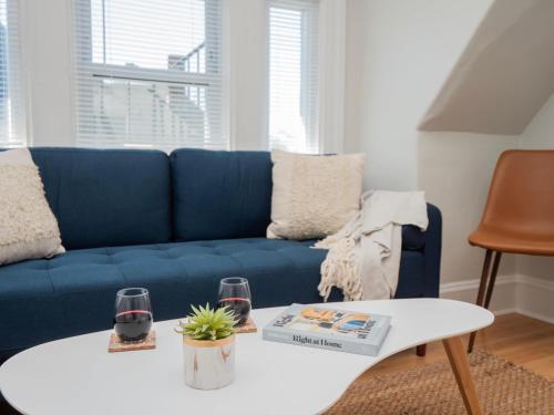 a living room with a blue couch and a table at Jennifer's Historic College Hill Apartment - The Lookout in Providence