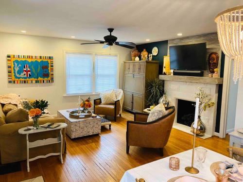 een woonkamer met een bank en een open haard bij A beautiful award winning bungalow in Indianapolis