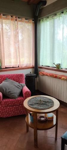 a living room with a couch and a table at Artenatura BeB in Terranuova Bracciolini