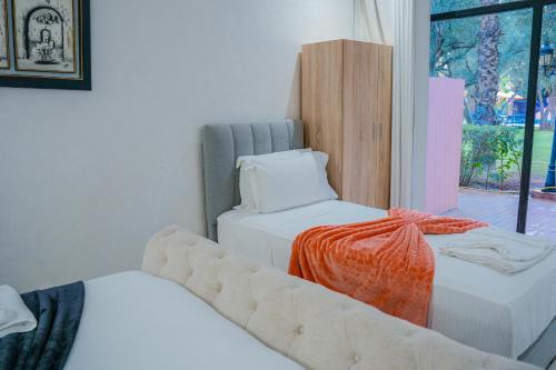 a living room with two beds and a couch at RIAD REDWAN in Marrakech