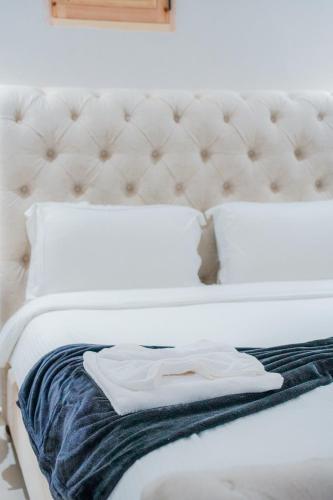 a white bed with a white shirt on it at RIAD REDWAN in Marrakech