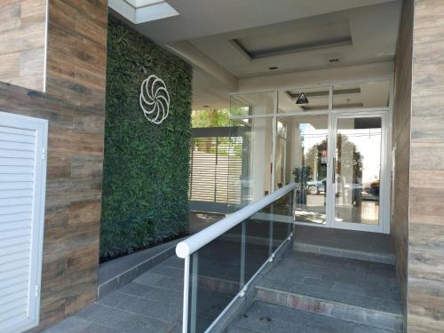 a facade of a building with a green wall at Departamento Céntrico in Puerto Madryn
