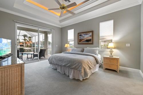 Marco Island Private Home on the Water في جزيرة ماركو: غرفة نوم بها سرير ومروحة سقف