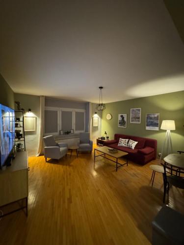 a living room filled with furniture and a flat screen tv at OldTown Apartments Ferhadija in Sarajevo