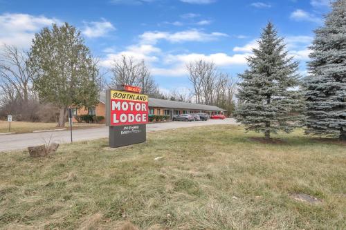 a motor lodge sign in front of a motel at Cozy 1BR Retreat in Brownstown – Relax Unwind in Woodhaven