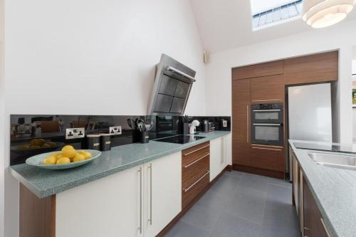 a kitchen with a bowl of fruit on a counter at Lakeview Callow near Foxford, Swinford and Westport in Foxford