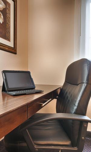 a black chair sitting in front of a desk with a laptop at Best Western Plus Brandywine Inn & Suites in Monticello