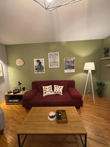 a living room with a red couch and a table at OldTown Apartments Ferhadija in Sarajevo
