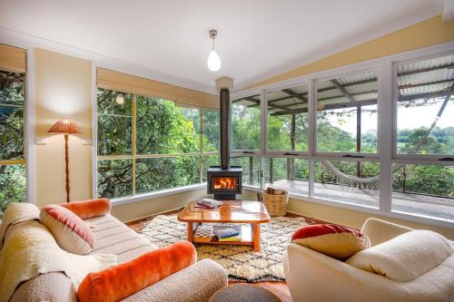 a living room with two couches and a fireplace at Family-Friendly Hinterland Stay l Nova Escapes in Dorroughby