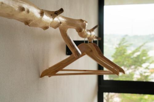 a wooden bird sculpture hanging on a wall at Hotel con Corazon Monteverde in Monteverde Costa Rica