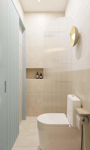 a bathroom with a white toilet and a sink at 68 Hotel Go Cong in Gò Công