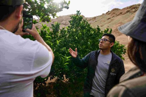 a man taking a picture of another man with a camera at Empedrada Ranch & Lodge - Hotel Asociado Casa Andina in Caral