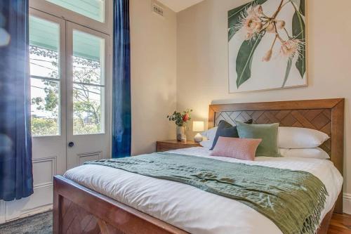 a bedroom with a large bed and a window at 2 mins walking to harbour bridge in Sydney
