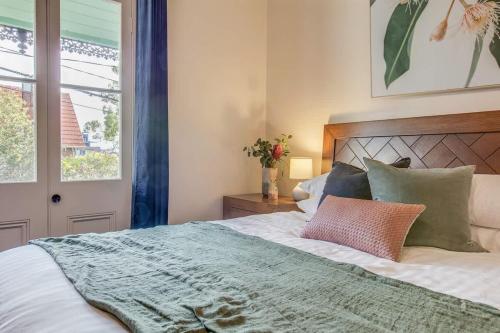 a bedroom with a large bed and a window at 2 mins walking to harbour bridge in Sydney
