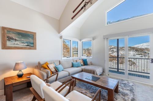 a living room with a couch and a table at The Stables Resort Perisher - Open All Year in Perisher Valley