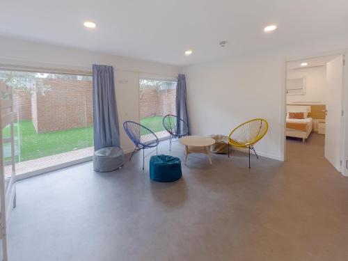 a room with chairs and a table and a window at Magnolia Suites & Stays in Porto