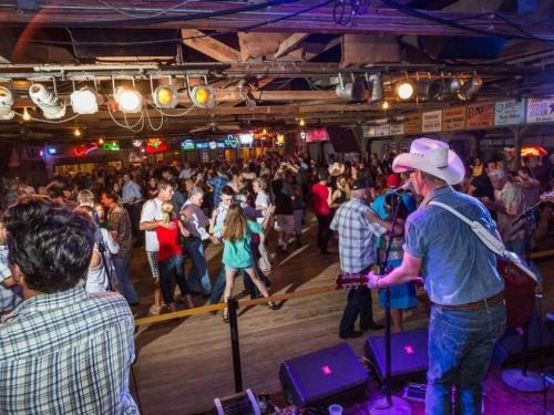 a crowd of people dancing on the dance floor at Hip Gruene Condo, Walk to Gruene Hall, On River! in New Braunfels