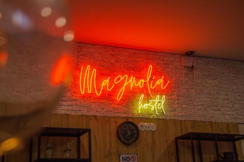 a neon sign on the wall of a restaurant at Magnolia Suites & Stays in Porto