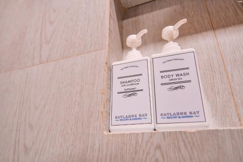 two signs on the wall of a bathroom at The Dome Hotel - Caylabne Bay in Ternate