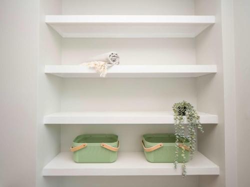 a room with white shelves and a potted plant at Jennifer's College Hill Apartment Close to Everything in Providence