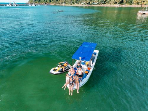 a group of people on a boat in the water at The Dome Hotel - Caylabne Bay in Ternate