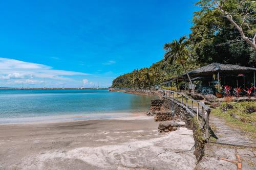 a beach with a hut and the ocean at The Dome Hotel - Caylabne Bay in Ternate