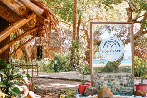 a sign for a love hotel in a garden at The Dome Hotel - Caylabne Bay in Ternate