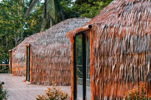 a straw hut with a thatched roof at The Dome Hotel - Caylabne Bay in Ternate
