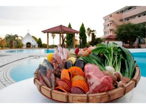 a basket of vegetables on a table next to a pool at Umibe no Kajuen - Vacation STAY 17483v in Konan