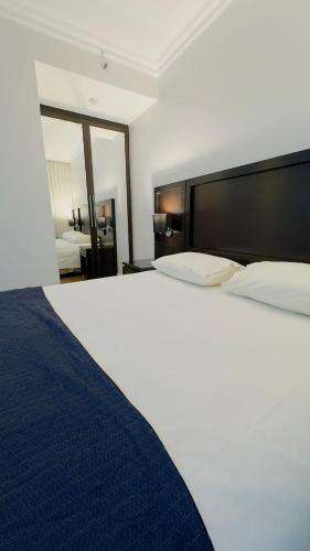a large white bed in a hotel room at HOTEL PERDIZES - FLAT Executivo - 1208 in Sao Paulo