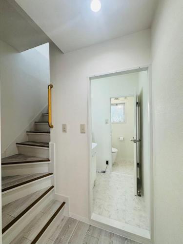 a white bathroom with a staircase and a toilet at LOFT-Hatsudai hostel初台SY0362 in Tokyo