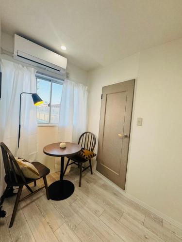 a room with a table and chairs and a window at LOFT-Hatsudai hostel初台SY0362 in Tokyo