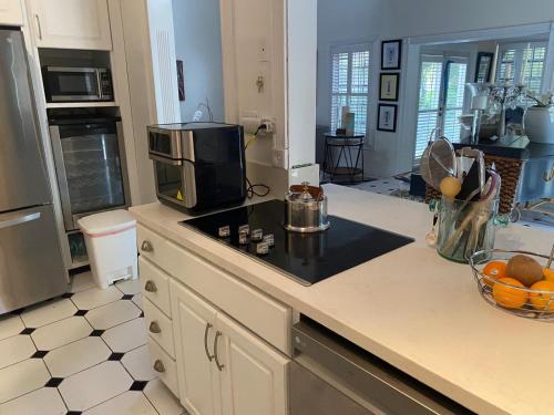 a kitchen with a counter top with a microwave at Beautiful Villa by the Beach in Nassau