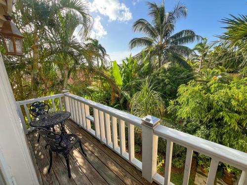 a balcony with a table and a table and trees at Beautiful Villa by the Beach in Nassau