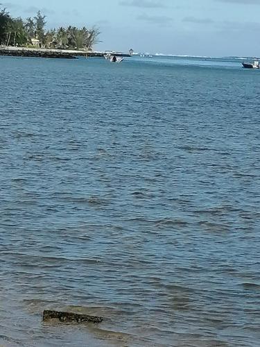 a large body of water with a boat in the distance at studio maryphil in Saint-Martin