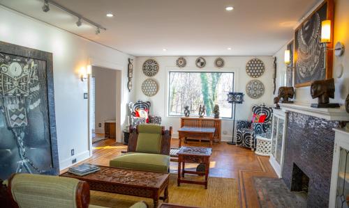 a living room filled with furniture and a fireplace at African Oasis Luxury Inn at the Gallery in Mount Vernon