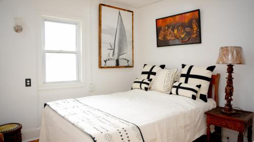 a bedroom with a bed with black and white pillows at African Oasis Luxury Inn at the Gallery in Mount Vernon
