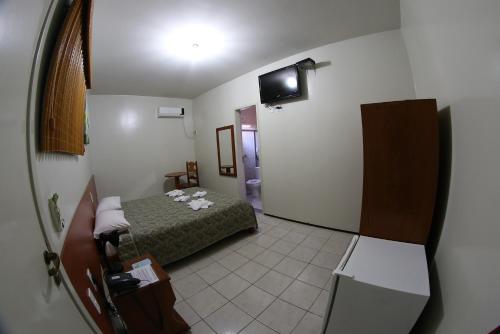 Ένα ή περισσότερα κρεβάτια σε δωμάτιο στο Hotel Poyares