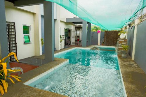 a swimming pool in the middle of a house at La Casa Vacanze Ph in Batangas City 5BR with Pool in Batangas City