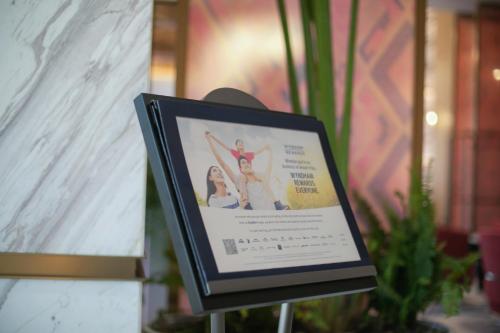 a framed picture of a woman doing gymnastics at Ramada by Wyndham Vientiane Central in Vientiane