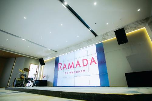 a stage with a sign for rambala on the wall at Ramada by Wyndham Vientiane Central in Vientiane